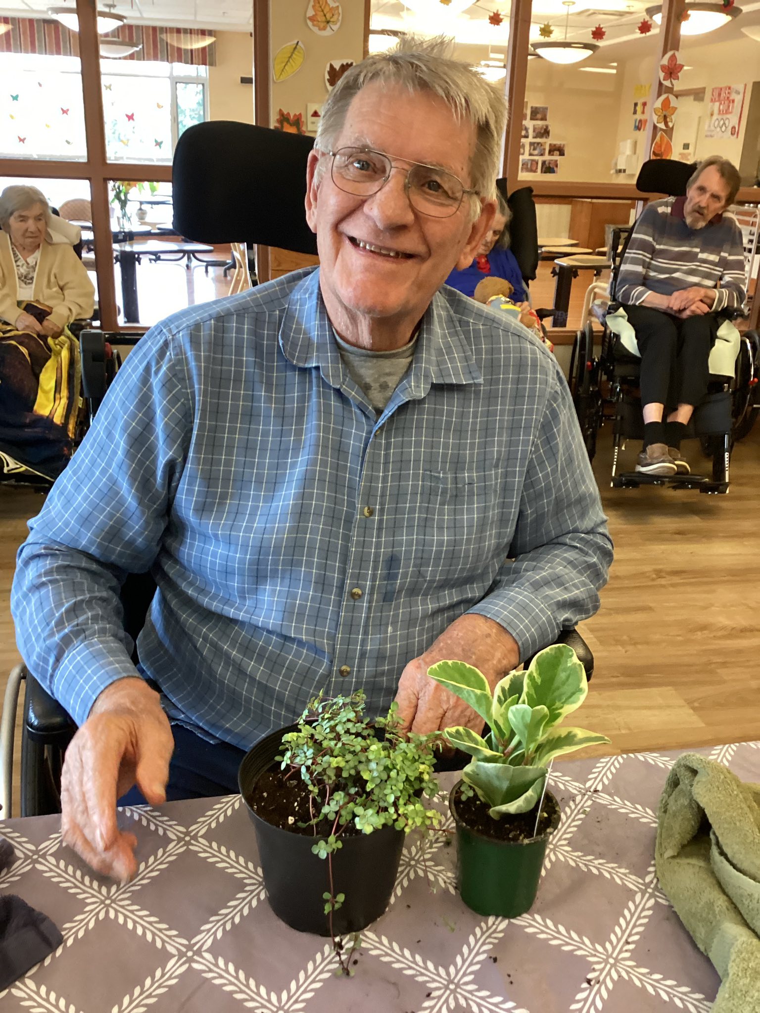 Elderly woman setting in chair with a smile